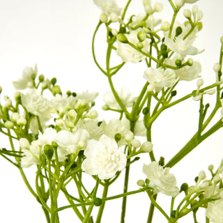 Close-up showing the texture of the artificial cream gypsophila petals and green plastic stems.