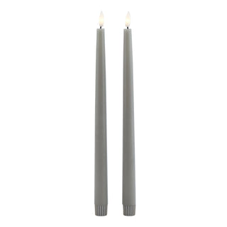 Two tall grey LED taper candles shown vertically against a white background.