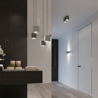 Grey cubic lights used as pendants, ceiling mounts, and wall sconces in a contemporary hallway interior.