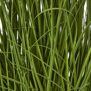 Close detail of the dense, vertical, grass-like green leaves of the faux allium.