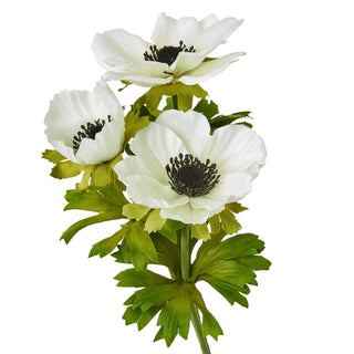 Artificial anemone stem close-up, showing three open white flowers with black centres and ruffled green leaves.