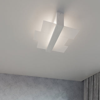 White ceiling light installed above a textured grey wall, showing the layered panels and wood-effect central support.