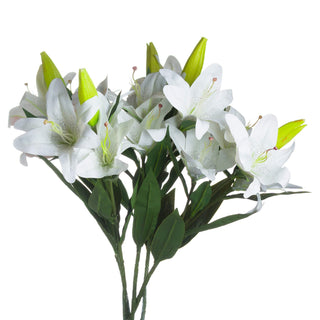 Bunch of faux white lilies with open blooms, green buds, and dark green leaves on a white background.
