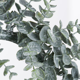 Extreme close-up showing the frosted texture on the artificial dusty green eucalyptus leaves and stems.