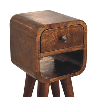 Close view of the curved chestnut bedside cabinet showing the single drawer, open lower shelf, and the top of the tapered legs.