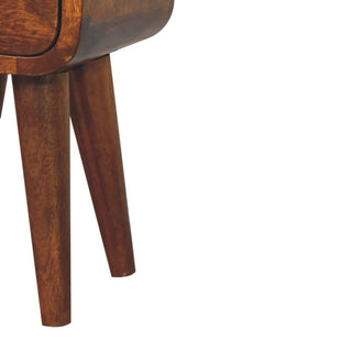 Close detail of the tapered, angled chestnut legs and the curved base of the bedside cabinet.