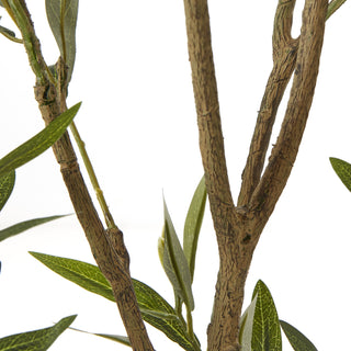 Tight close-up of the artificial tree's textured brown stems and branches.