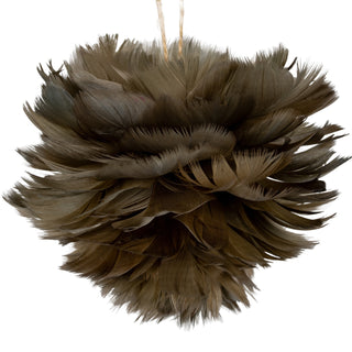 Full view of the dense, spherical fawn feather decoration suspended by a natural twine loop.