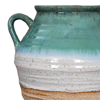 Detail of the amphora handle where the turquoise glaze meets the ribbed white band and unglazed beige body.