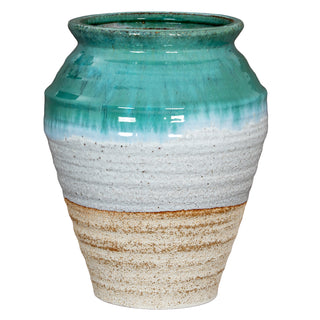 Full view of ceramic vase. Glossy turquoise glaze fades to textured white and unglazed beige base.