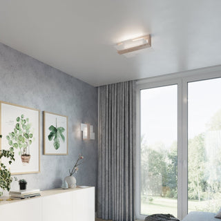 Ceiling light fixture illuminating a modern room with grey textured walls and large windows.