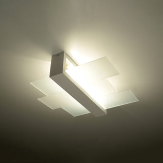 Diffused light glowing through the layered rectangular panels of the white ceiling fixture.