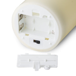 The base of the cream LED pillar candle with the battery compartment open and switch visible.