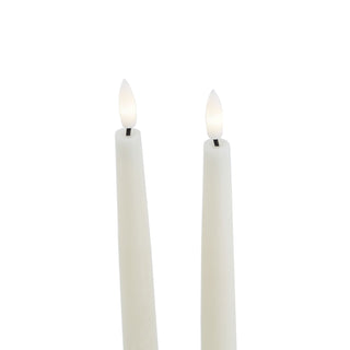 Close-up of the tops of the two taupe flameless candles, highlighting the illuminated LED wicks.