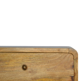 Close-up detail of the rounded top edge, natural wood grain, and circular brass handle.