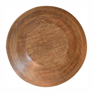 Overhead view of the wooden base of the bowl, showing the rich grain and carved footing detail.