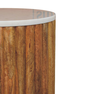 Detail showing the textured wooden fluting and the smooth white marble top edge.