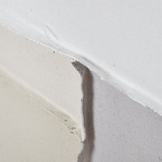 Close detail of the artwork's layered composition, showing rough edges of cream and beige canvas.