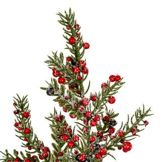 Close detail of the tree's frosted green branches and glossy red and black artificial berries.