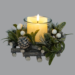 Close-up of the candle wreath base featuring frosted pinecones, white berries, and dark green mistletoe leaves.