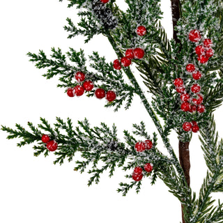 Close-up detail of the artificial frosted pine foliage, red berries, and white flocking texture.