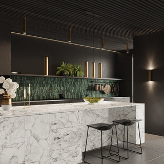 Gold cylindrical fittings used as pendants, flush lights, and wall lights in a modern kitchen.