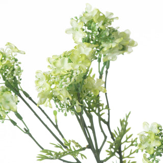 Close detail of the artificial lime green flower heads and clustered white buds.