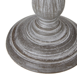 Close detail of the distressed grey wood plinth and turned moulding at the base of the table lamp.