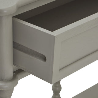 Close-up of the grey console table showing a drawer pulled open, revealing the interior and the slotted drawer front detail.