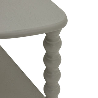 Close detail of the grey painted wood texture on the tabletop edge and the upper bobbin turned leg.