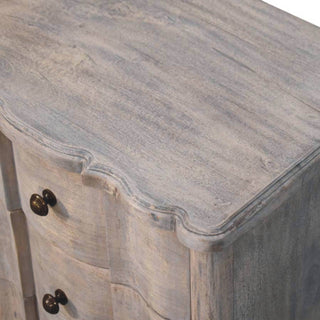 Detail shot showing the distressed wood grain on the top surface and the serpentine edge profile.