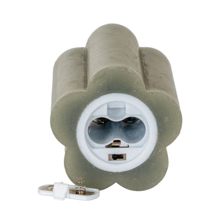 Underside of the grey fluted LED candle showing the battery compartment and on/off switch.