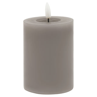 Grey cylindrical wax LED candle showing the lit plastic flame element. Plain product shot.