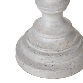 Close-up showing the bottom edge and flared foot of the distressed grey wooden lamp base.