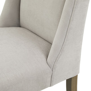 Detail shot of the grey fabric upholstery showing the seam where the seat meets the curved side wing.