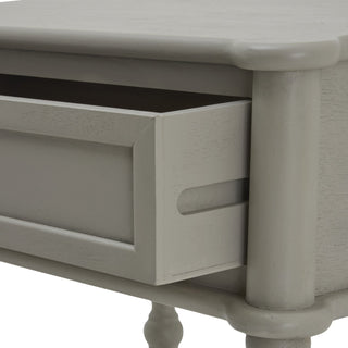 Detail shot of the grey side table drawer pulled open, showing the recessed handle slot.