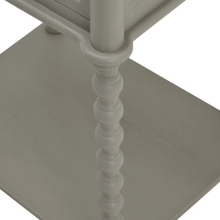 Close-up of the grey bobbin-turned leg joint where it meets the lower shelf.