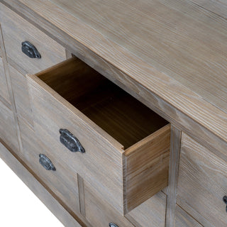 Close-up of the weathered grey chest showing one small drawer pulled open, revealing the internal construction.