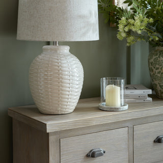 Close-up of the chest's light wood top surface, showing the grain and a dark metal cup handle.
