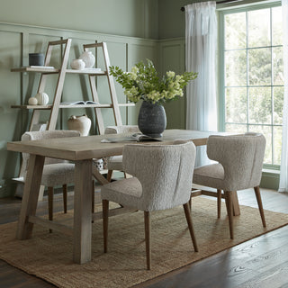 Styled apex unit placed behind a wooden dining table and chairs in a sage green dining room.