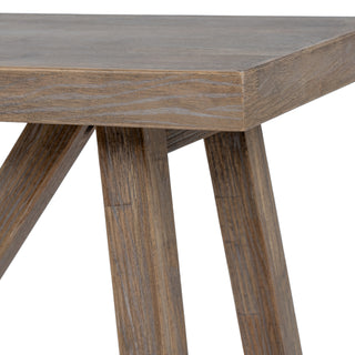Close-up of the console table top edge intersecting with the angled legs, highlighting the weathered wood finish.