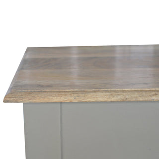 Detail shot of the natural wood grain on the desktop meeting the hand painted taupe frame.