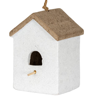 Three-quarter view showing the rough white textured material of the birdhouse body and the contrasting brown pitched roof.