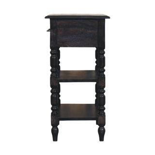 Side profile of the dark wood turned-leg table showing its depth, upper drawer, and two lower storage shelves.