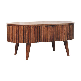 Oval coffee table with textured wooden body and four tapered legs, viewed from a slight angle.