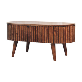 Oval coffee table showing the ribbed wooden body and the subtle gap for the hidden drawer.