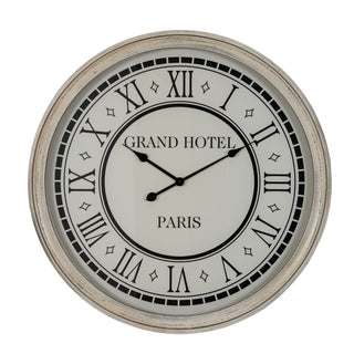 Circular wall clock with distressed grey frame, white face, black Roman numerals, and Grand Hotel Paris text.