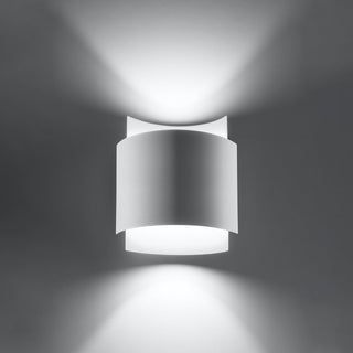 Lit white wall lamp showing wide beams of light projected upwards and downwards.