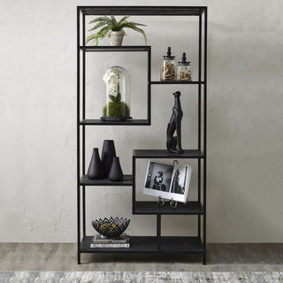 Industrial black shelving unit displayed in a room setting, filled with decorative accessories and books.