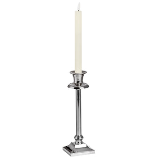 One ivory LED dinner candle standing in a tall silver-coloured candlestick holder.